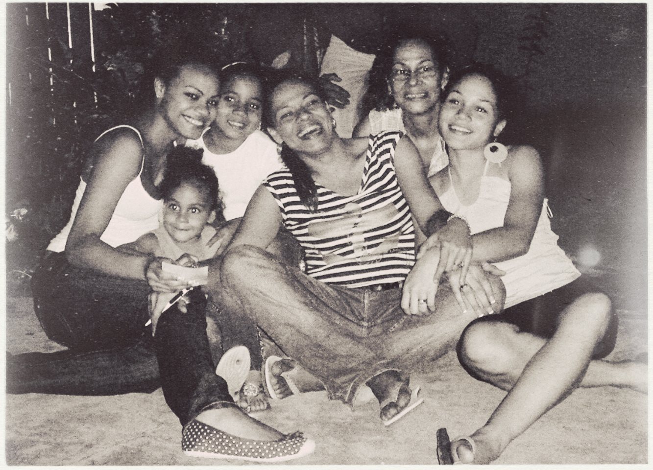 Black-and-white photo of Amanda's mother, her three younger sisters, and her grandmother sitting close together.
