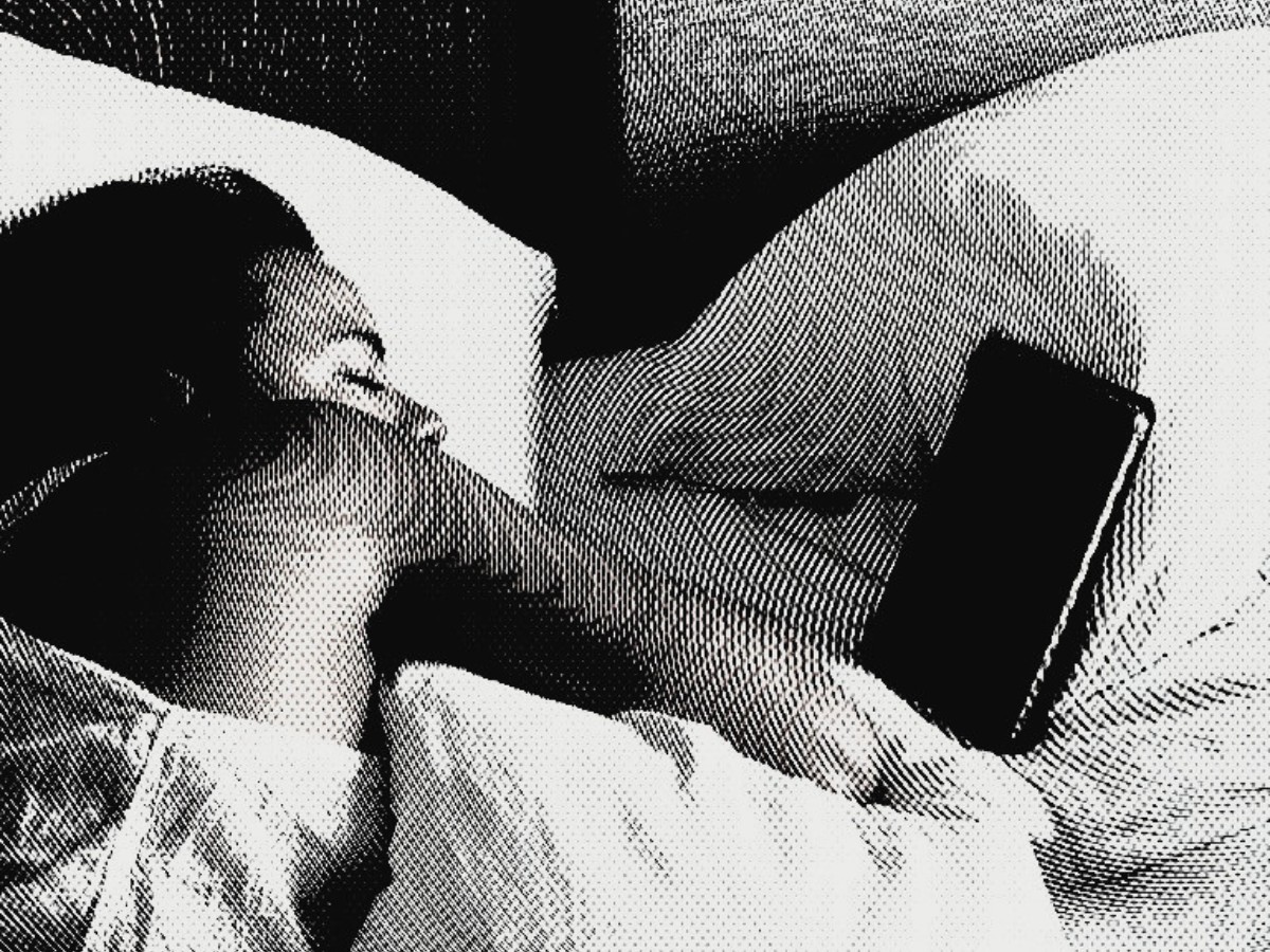 High-contrast halftone photograph of Amanda asleep on a bed, her phone lying on the covers beside her.