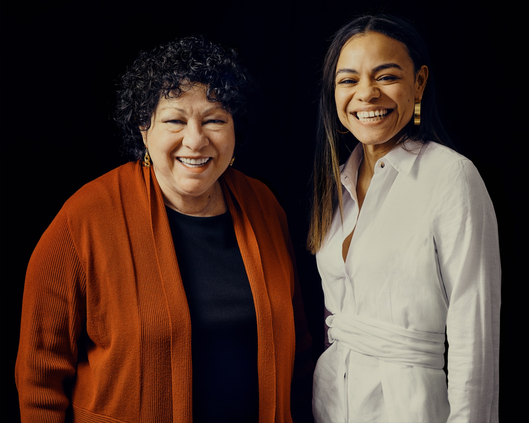 Justice Sonia Sotomayor and Amanda Saviñón smiling side by side against a black background.